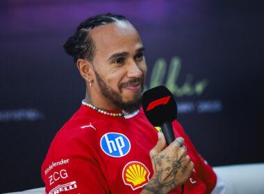 a man in a red shirt holding a microphone
