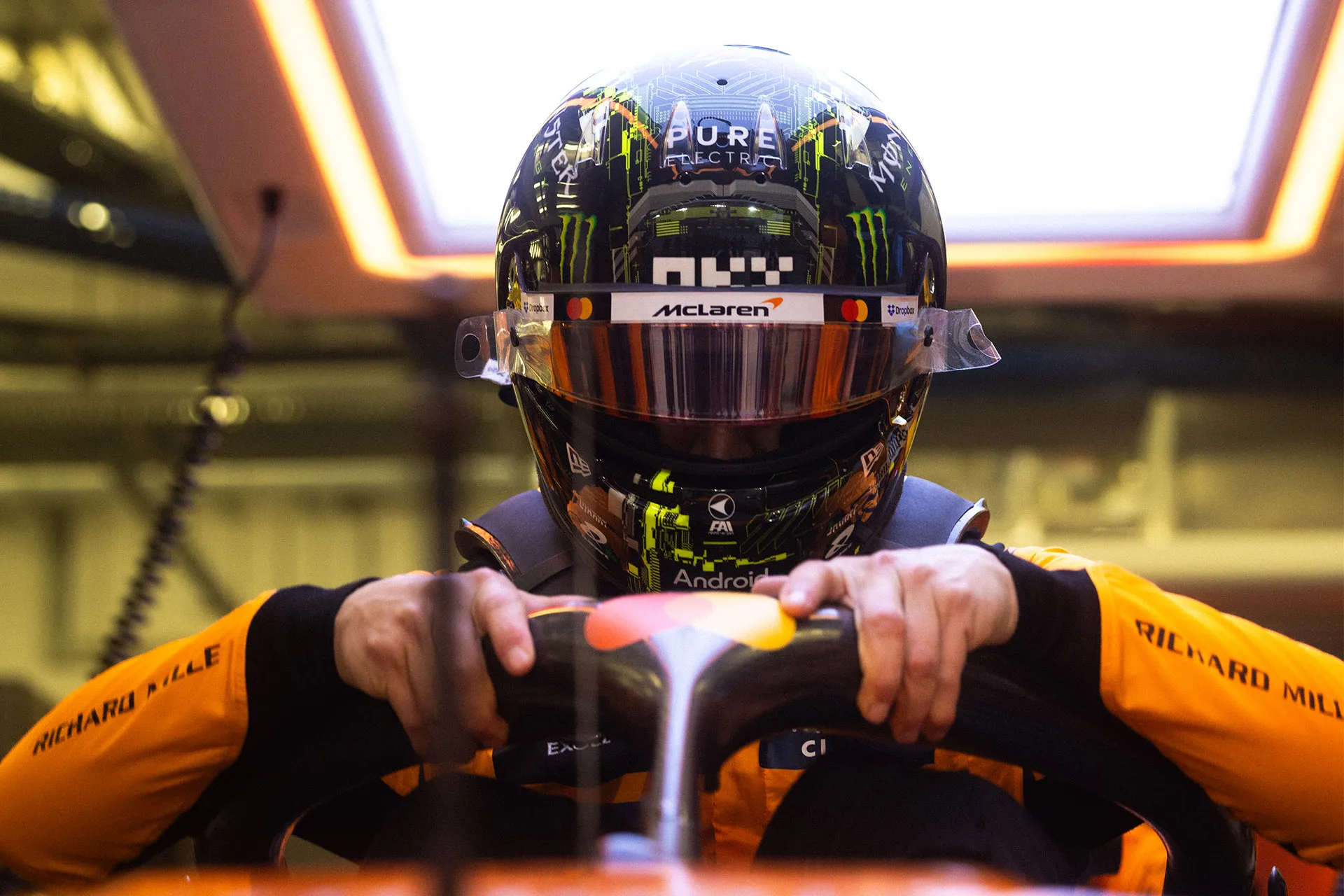 a man wearing a helmet and holding a steering wheel